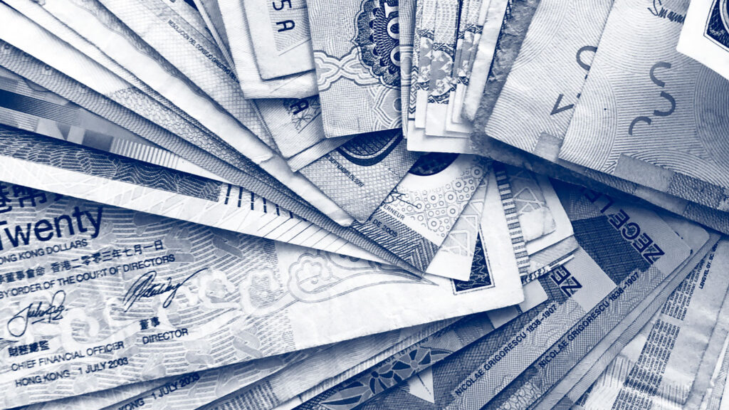 A macro-photograph of assorted global banknotes.